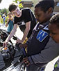 UW student shows middle school students EcoCAR engine (photo by Ellen Banner, Seattle Times)