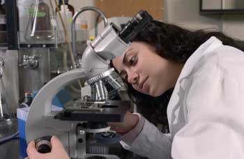 student at microscope