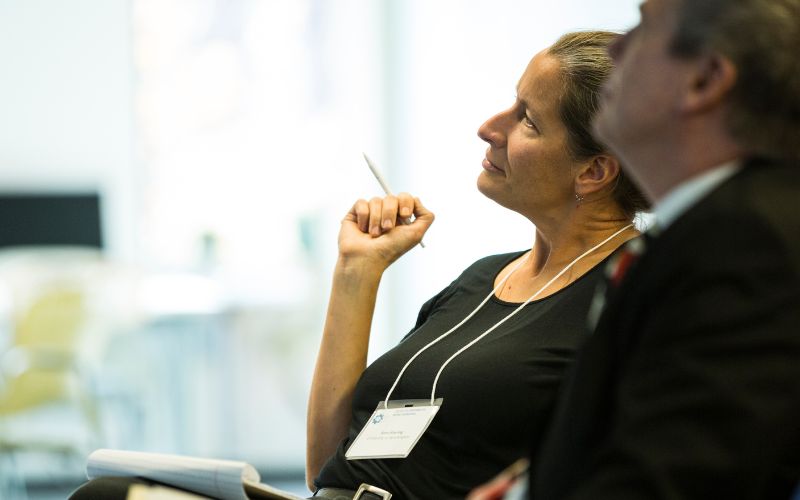 Two people listening intently to presentation