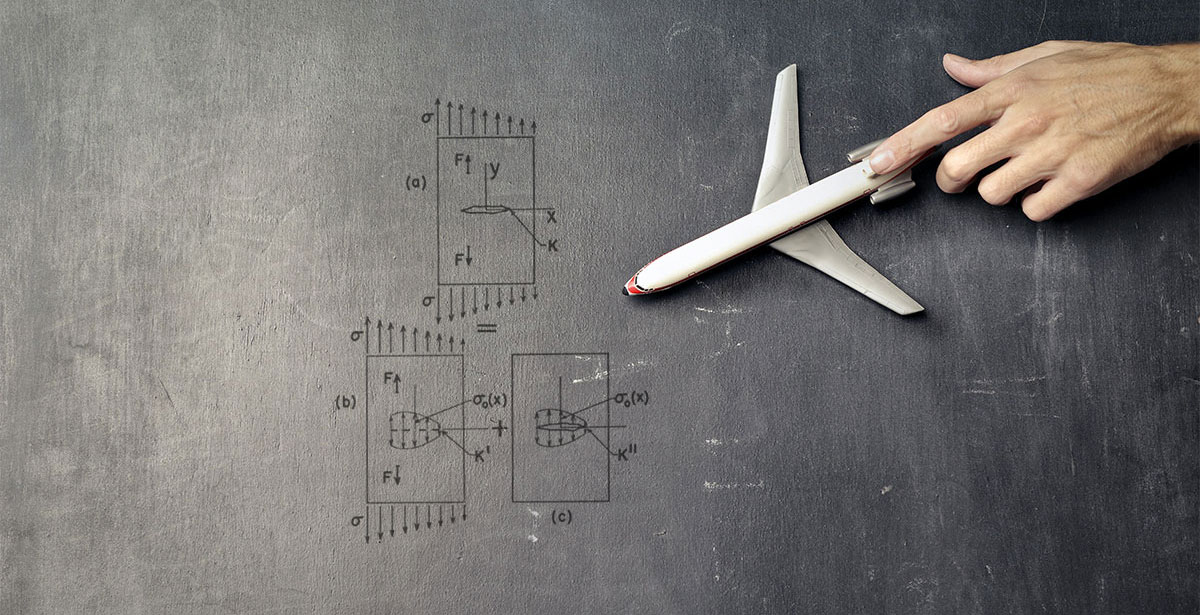 a hand pointing at a model airplane