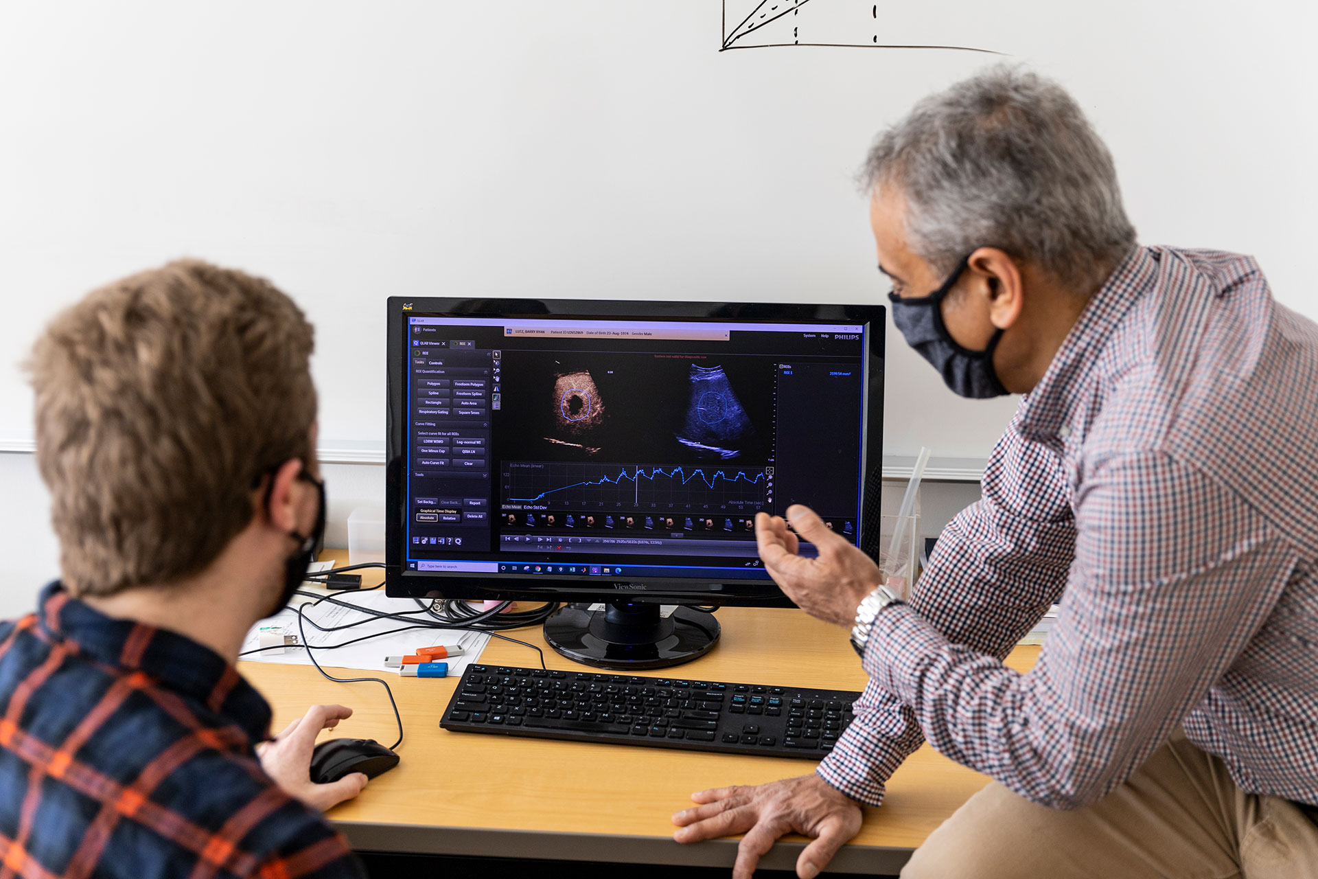 Bioengineering Ph.D. student Connor Krolak and Averkiou examines Lutz's lesion on a monitor 