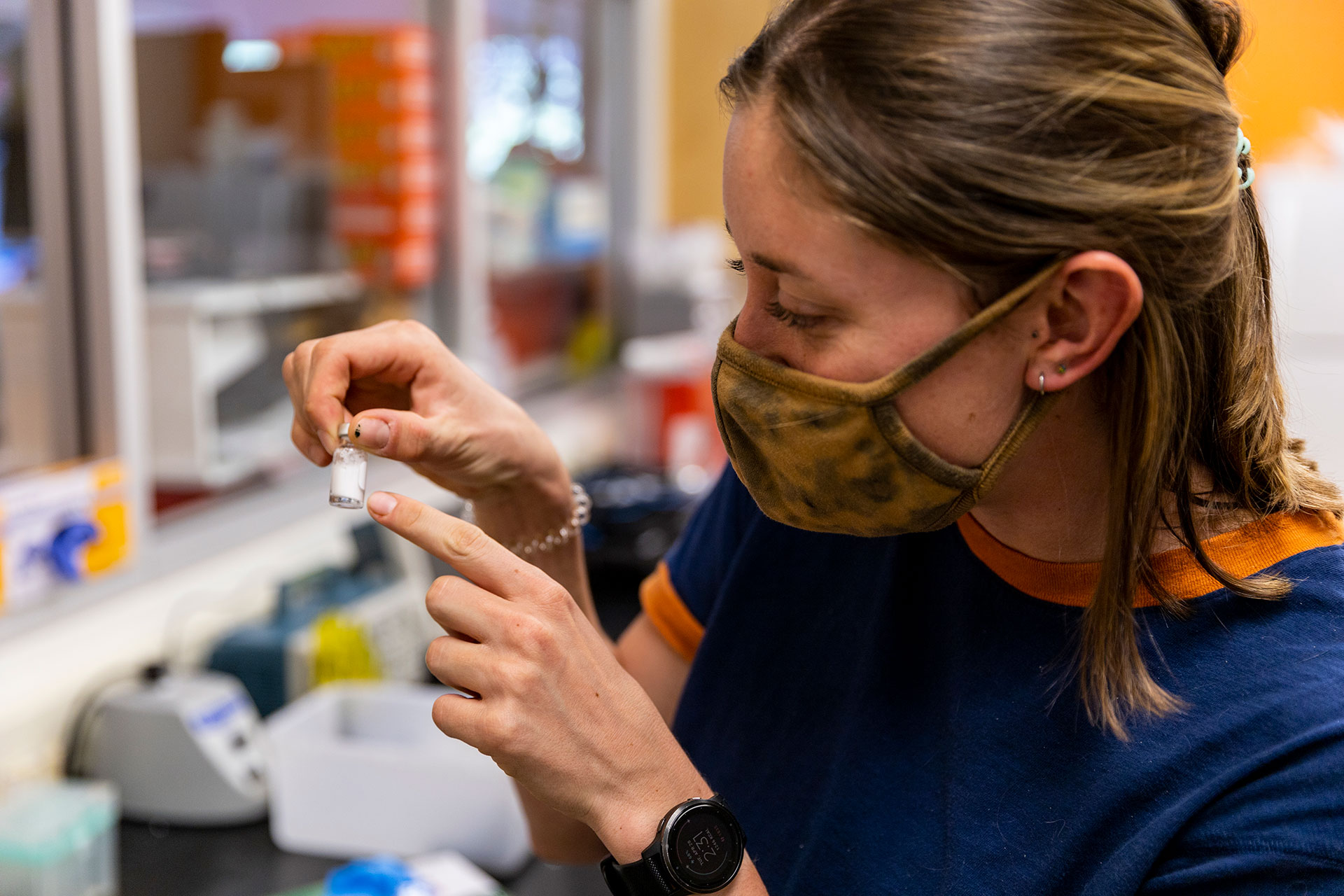 Ph.D. student Sara Keller examines a vial of microbubbles 