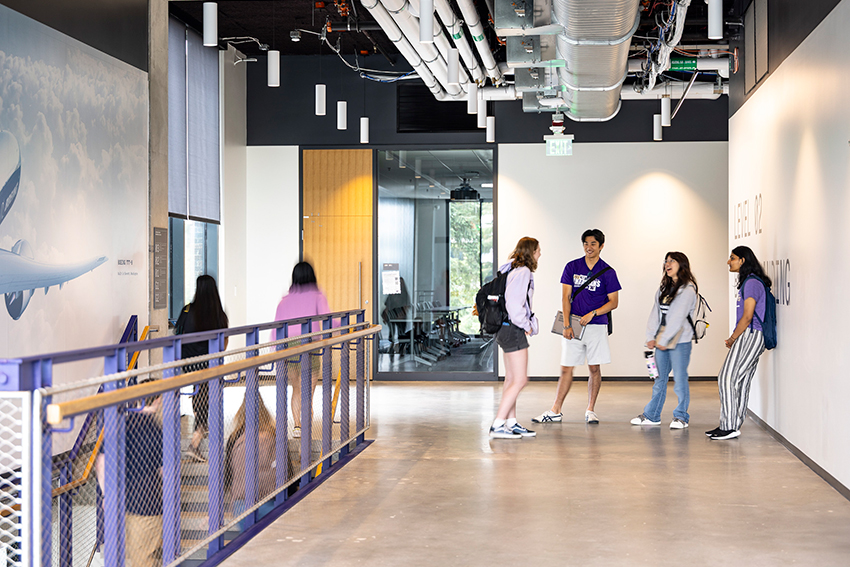 Students in hallway of IEB near a staircase
