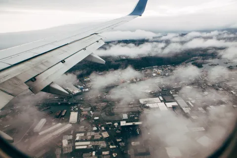 airplane flying over a city