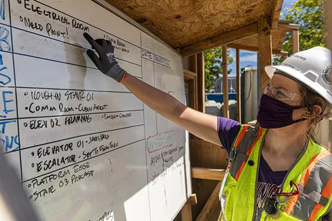 CEE senior Bailey Griffin points at the slated schedule/operations for the day