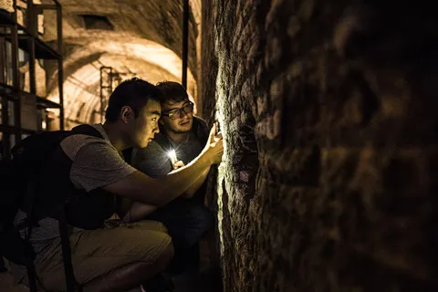 Daniel Bi and Joel Corlew in the Mithraeum of the Baths of Caracalla, an underground space once used for religious gatherings.