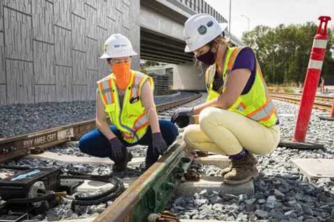 STARS graduate Bailey Griffin (right) during an internship working on light rail development.