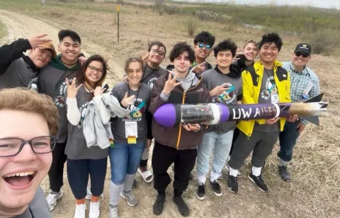 Students hold a rocket