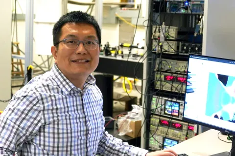 Xiaodong Xu sitting near a computer