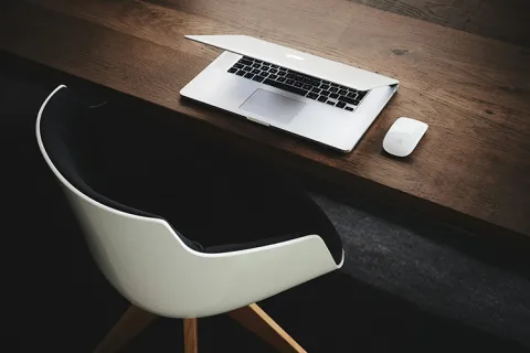 Chair next to a laptop on a desk