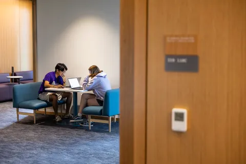 Students sitting at table within the IEB
