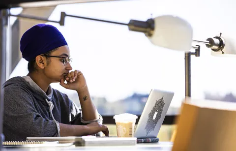 a young person working at a laptop