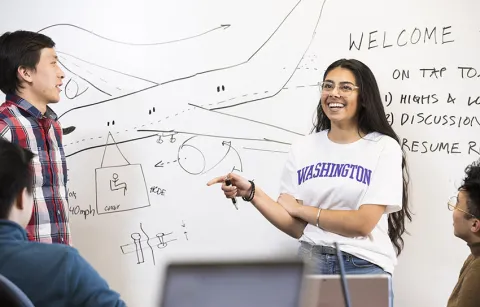 students in front of a white board