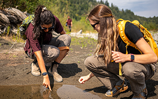 Two students working in the field near nature