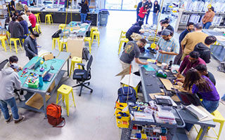 Groups of people working on tables in a workshop-style setting