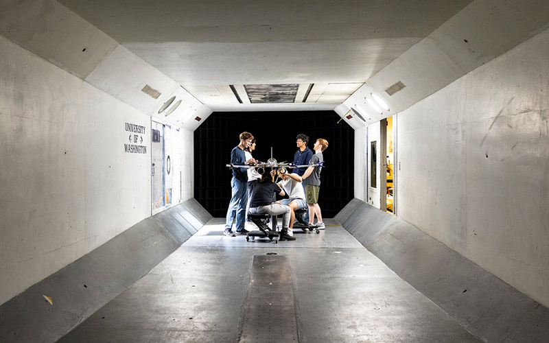 Students standing around model in the Kirsten Wind Tunnel