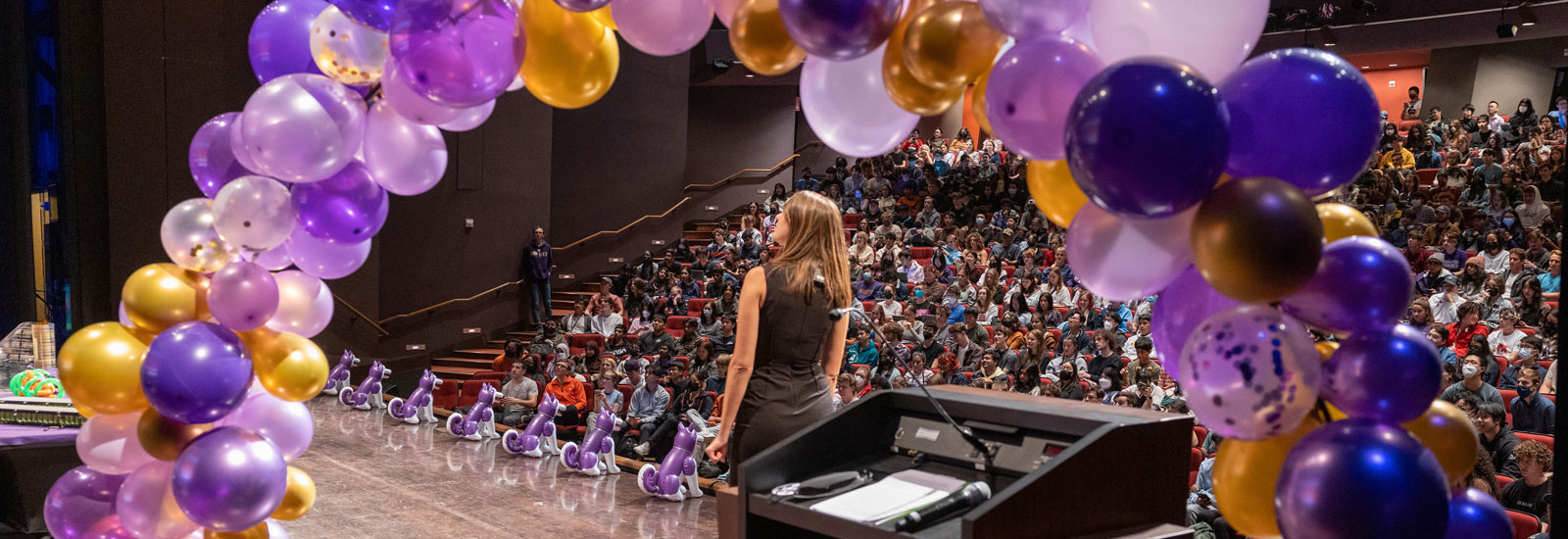 A woman standing on stage at a UW event
