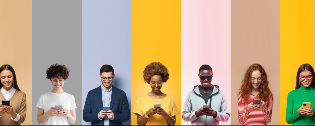 Seven people, each against differently colored vertical backgrounds, looking at their smartphones.