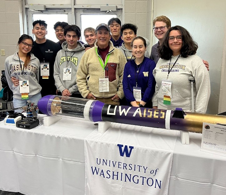 The AISES UW team standing with first Indigenous man in space, John Herrington and their competition rocket and drone