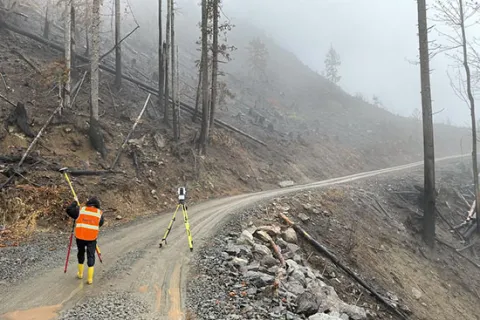 A researcher uses RAPID monitoring technology to collect data in the aftermath of Washington’s Bolt Creek wildfire in 2022. Photo courtesy of RAPID center.