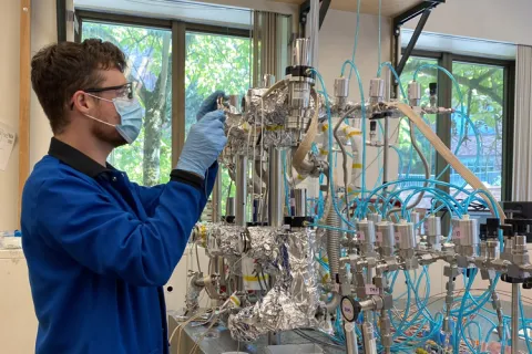 Person wearing protective gear working in lab