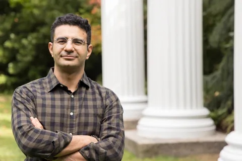 UW ECE Assistant Professor Sajjad Moazeni stands next to columns in Sylvan Grove on the UW campus.