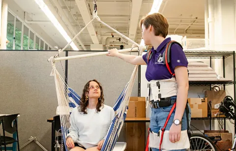 Students testing the harness-style mobility system in a workshop setting