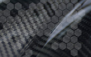 Hexagonal grid over a carbon fiber background.