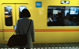 Person standing in front of train